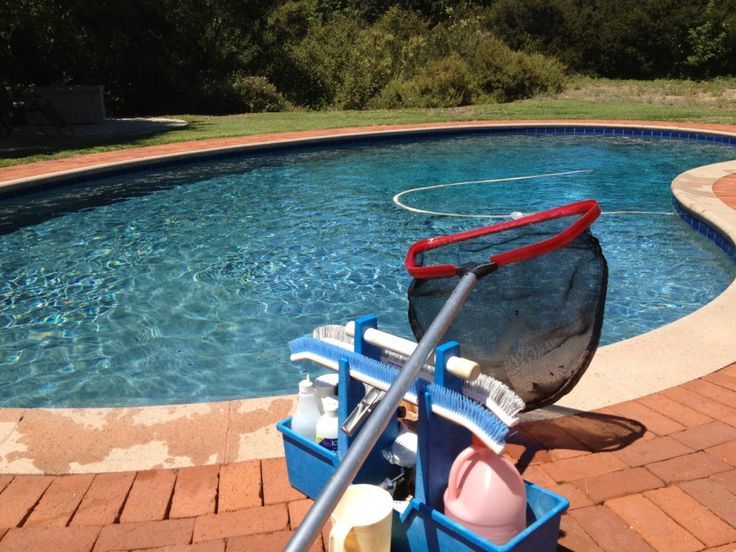 Pool cleaning and testing kit with test strips and solutions used to check pH, chlorine, and stabiliser levels in swimming pool water