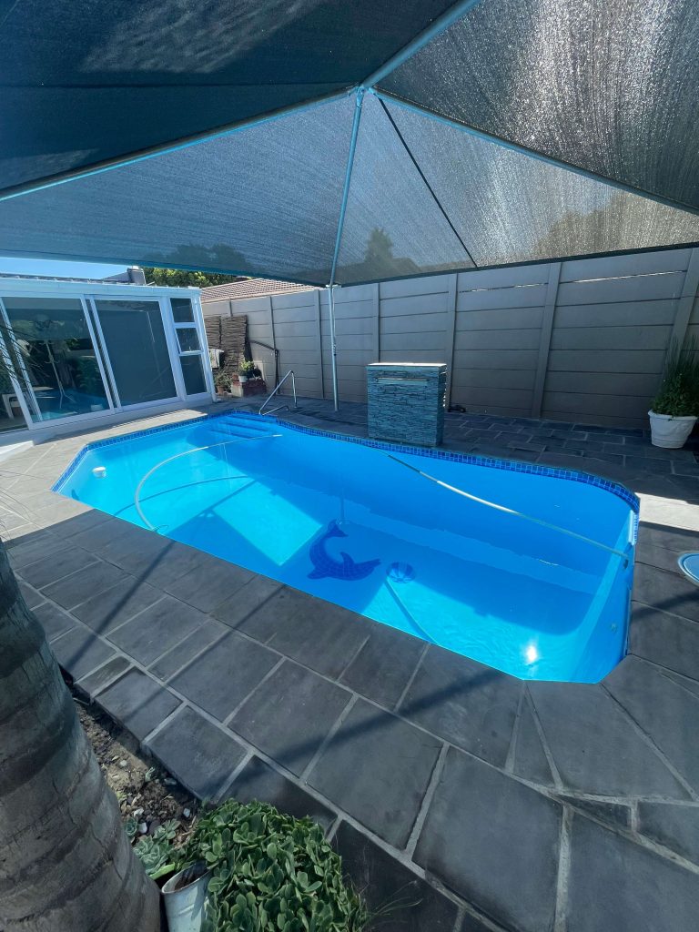 New coping stones installed around renovated swimming pool in Cape Town