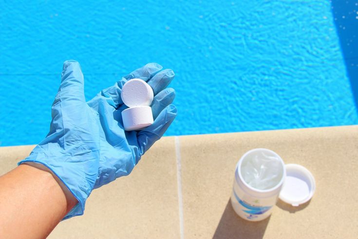 Close-up of pool chlorine tablets being added to a backyard swimming pool to maintain safe chlorine levels in Guest house pool Stellenbosch Frranschhoek