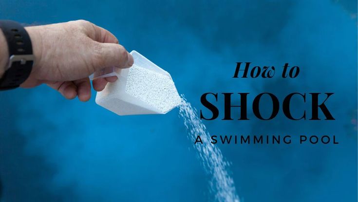 Pouring pool shock into a backyard swimming pool for water sanitisation