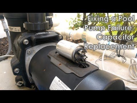 Close-up of a swimming pool pump with the capacitor exposed for testing or repair