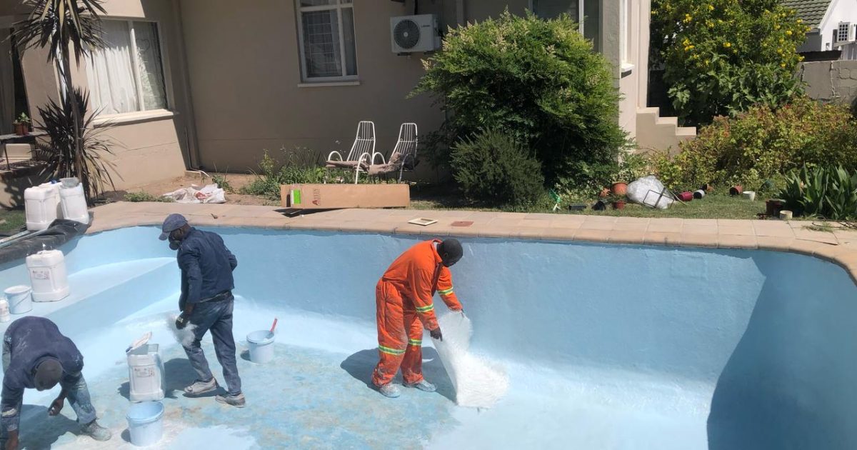 "Pool technicians fibre lining a swimming pool during expert installation process featured in our project lookbook."