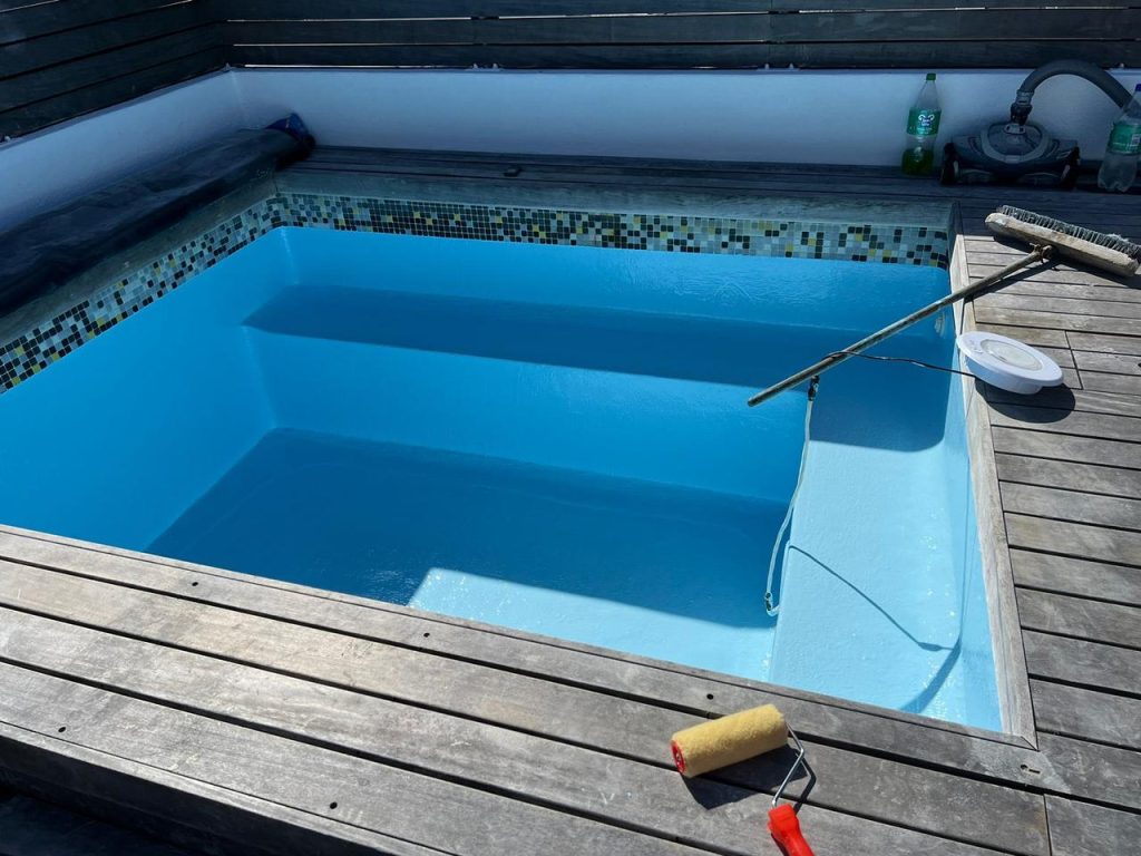 Neglected pool undergoing renovation in Cape Town, including fibreglass lining, tile replacement, and structural repairs by Pools Reno.

