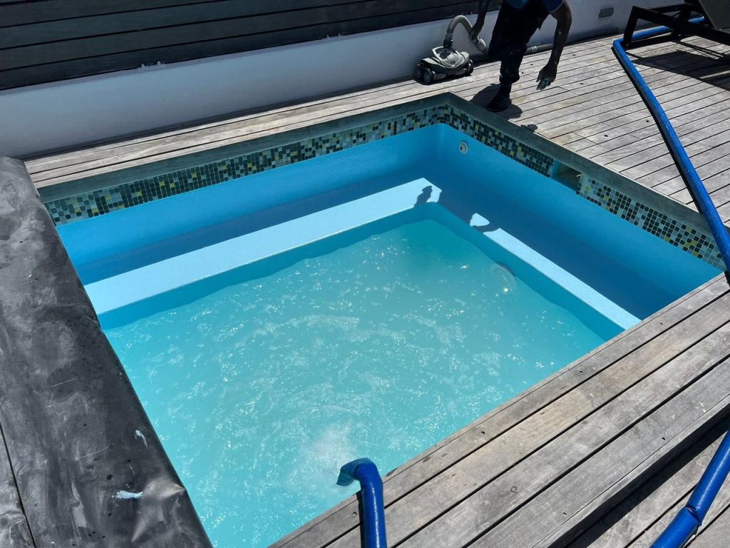 Neglected swimming pool fully renovated with fresh resurfacing, new coping tiles, and fibreglass lining by Pools Reno in Cape Town.


