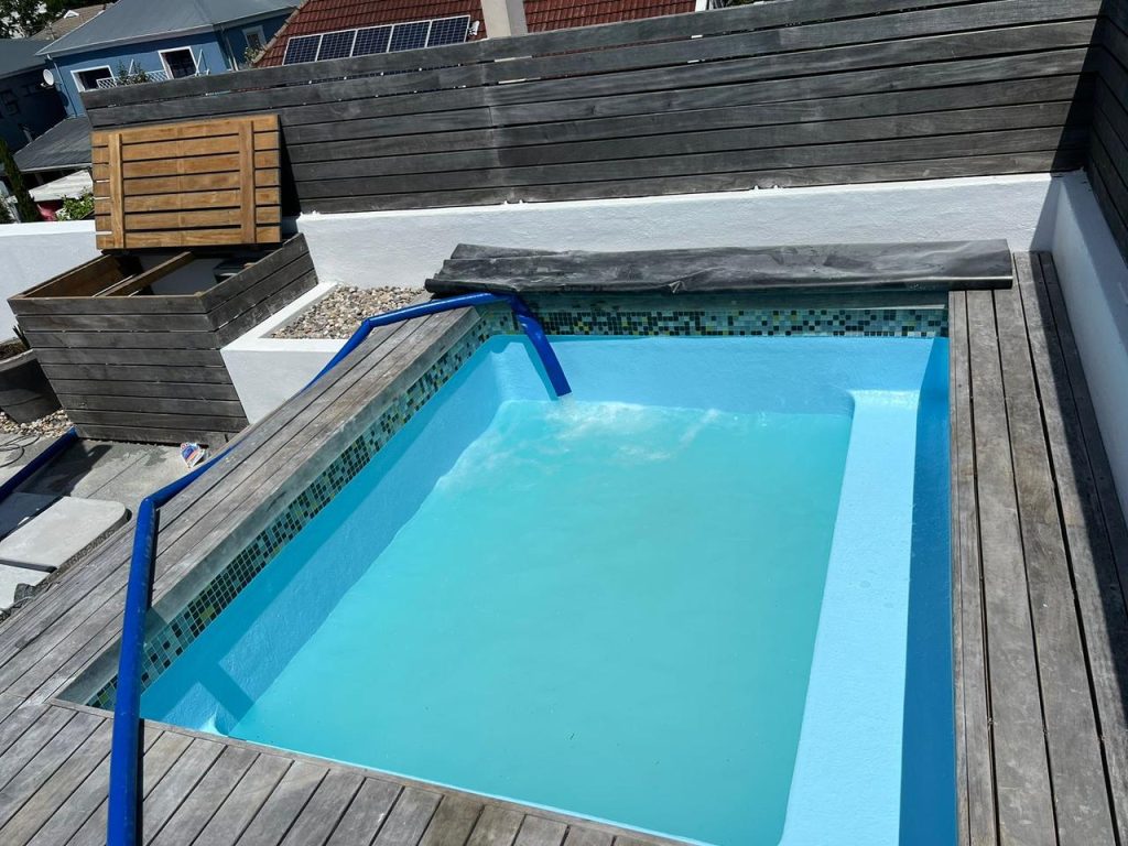 Fibreglass swimming pool installation in Bellville with modern landscaping