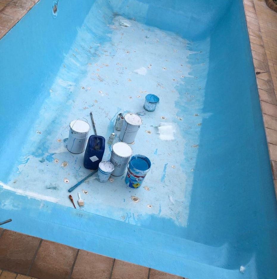 Technician repairing fibreglass pool shell with fungal contamination in Cape Town