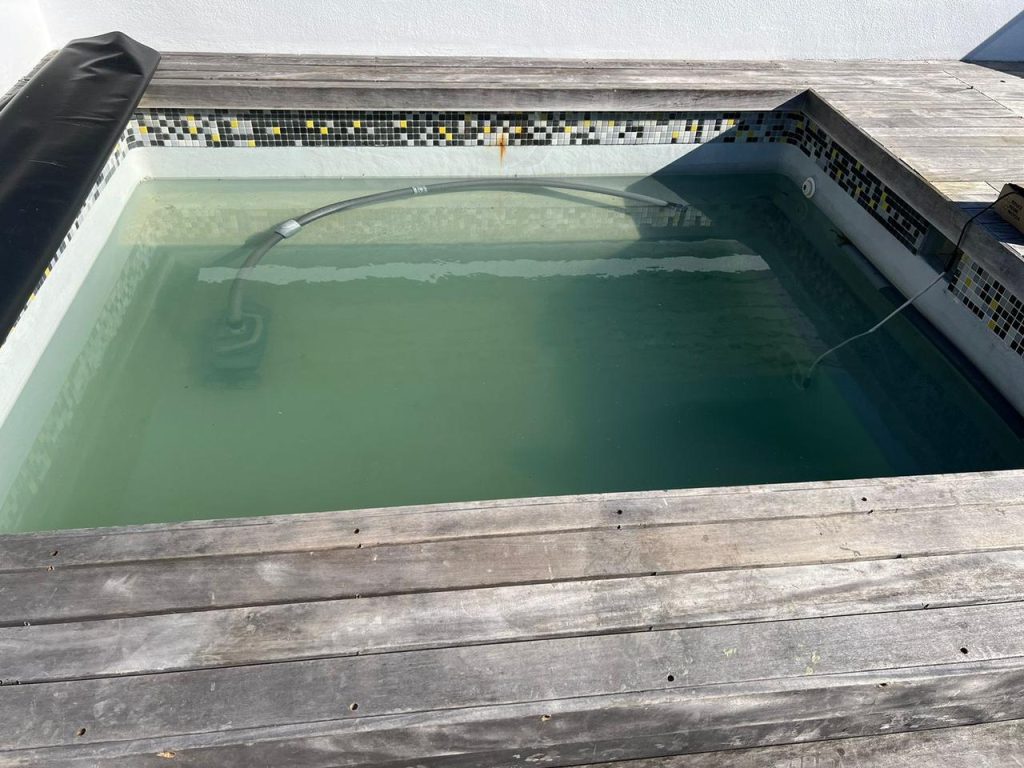 Green, discoloured pool water with visible algae growth caused by poor filtration and chemical imbalance