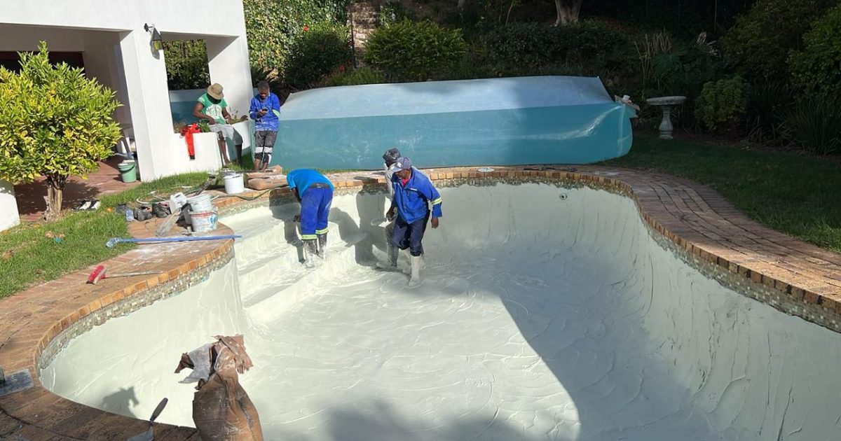 Pools Reno team applying fresh plaster on a worn gunite swimming pool in Cape Town