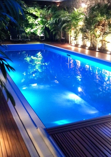 Well-maintained residential swimming pool in Cape Town, showcasing optimal water clarity and modern pump system, representing proper pool maintenance, renovation, and heating upgrades.