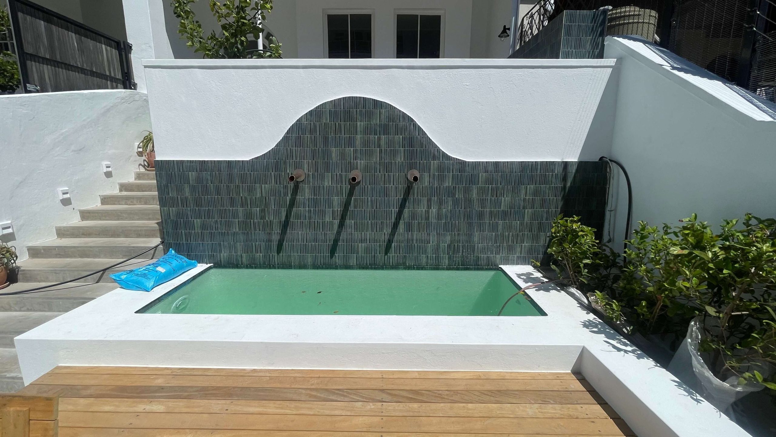 Concrete steel-reinforced swimming pool with fiberglass-lined finish and surrounding wooden deck, located on the front porch of a residential home in Sea Point, Cape Town—offering a stylish, durable, and low-maintenance outdoor feature. Concrete steel-reinforced swimming pool with fiberglass-lined finish and surrounding wooden deck, located on the front porch of a residential home in Sea Point, Cape Town—offering a stylish, durable, and low-maintenance outdoor feature.