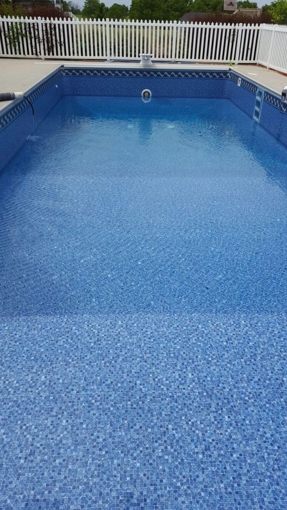 Vinyl swimming pool installation in progress with reinforced wall panels, smooth liner placement, and clear blue water – modern backyard pool upgrade in Cape Town.
