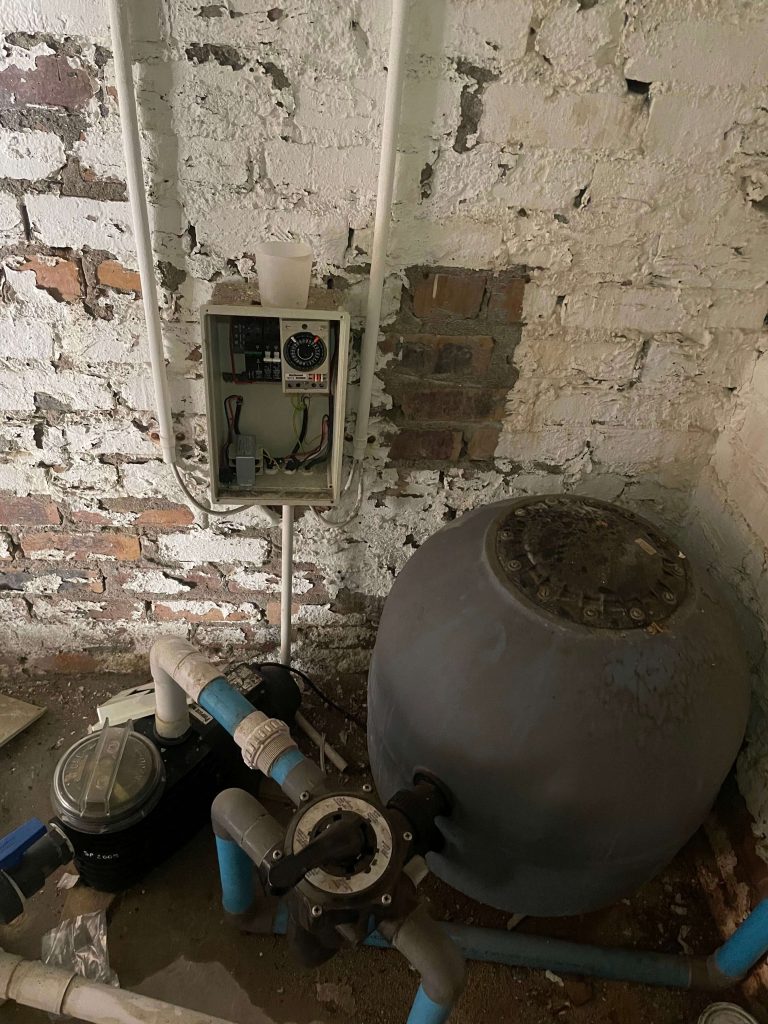 Pool sand filter, pump and timer checked during a routine pool service
