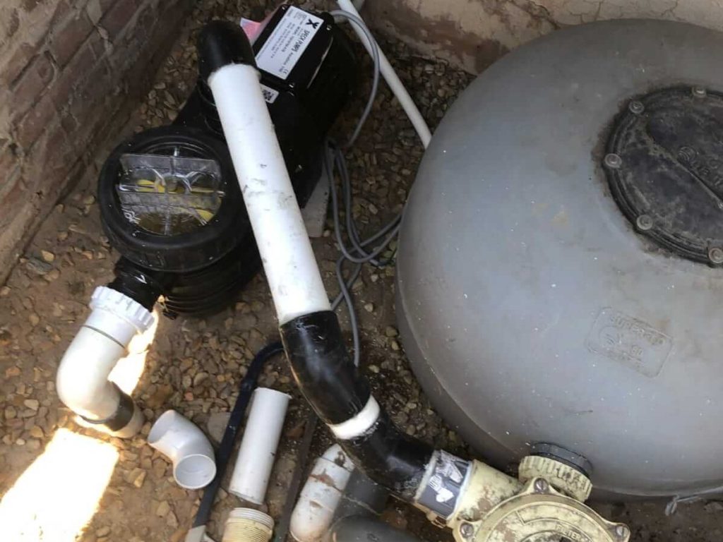 Pump and filter plumbing with unions and pipe fittings, a common spot for small pool plumbing leaks