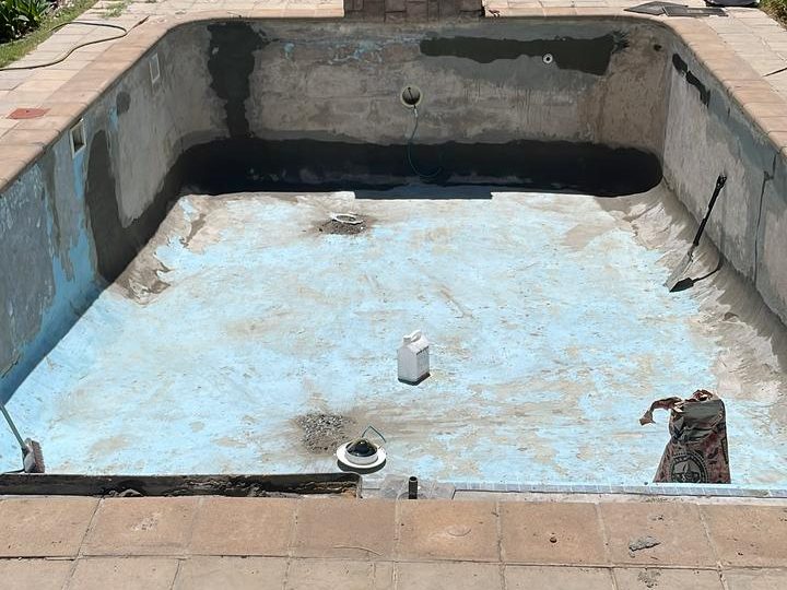 Technician inspecting hairline pool crack with moisture meter in Cape Town pool