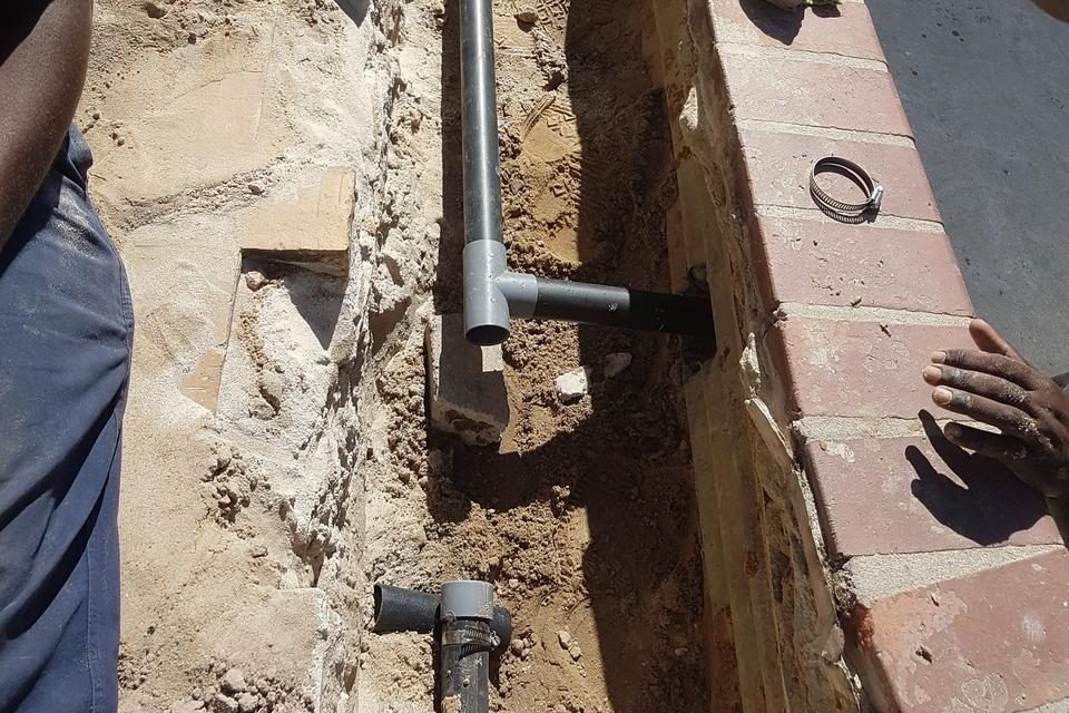 "Pool jet piping leak detection and repair services, with technician inspecting and fixing pipe issues."