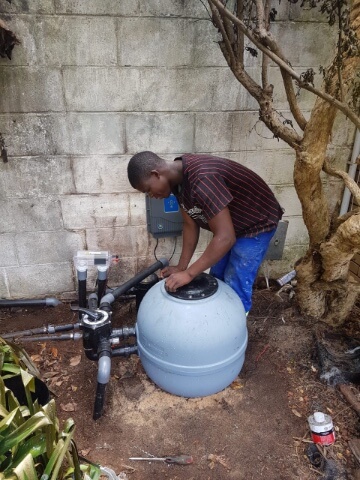 Technician diagnosing pool pump issues in Cape Town.