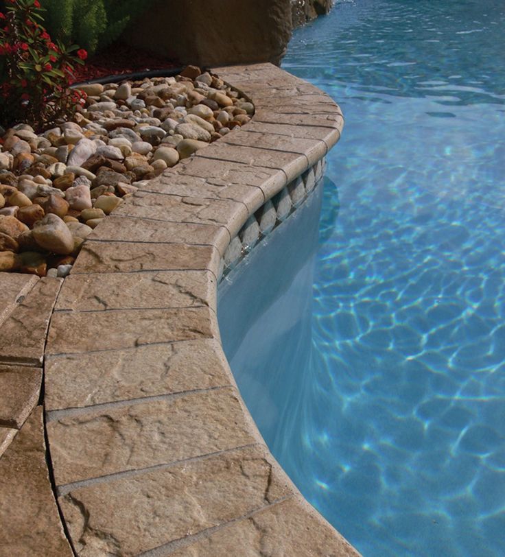 Close-up view of natural stone coping installed on a modern swimming pool in Cape Town, South Africa.