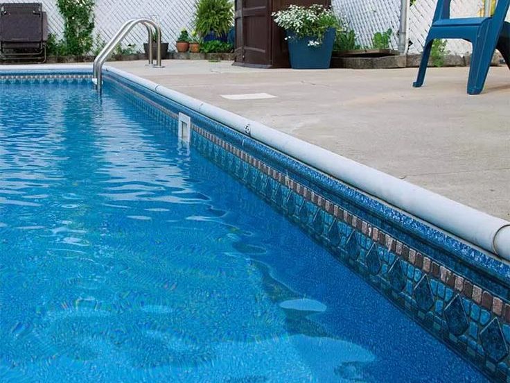 Installing a vinyl pool liner in a backyard in Strand