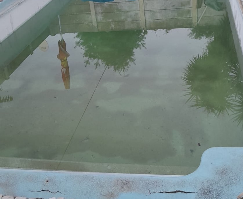 Cracked fibreglass pool step showing delamination and surface damage