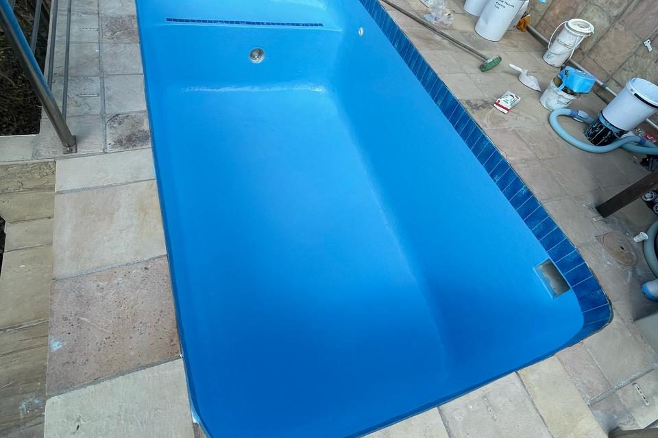 Bright blue pool after resurfacing with non-slip fibreglass topcoat