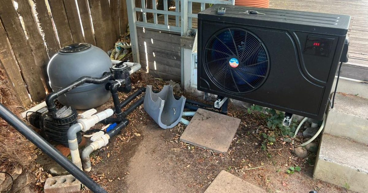 Pool heat pump installation in a residential backyard, showing energy-efficient swimming pool heating setup in Cape Town