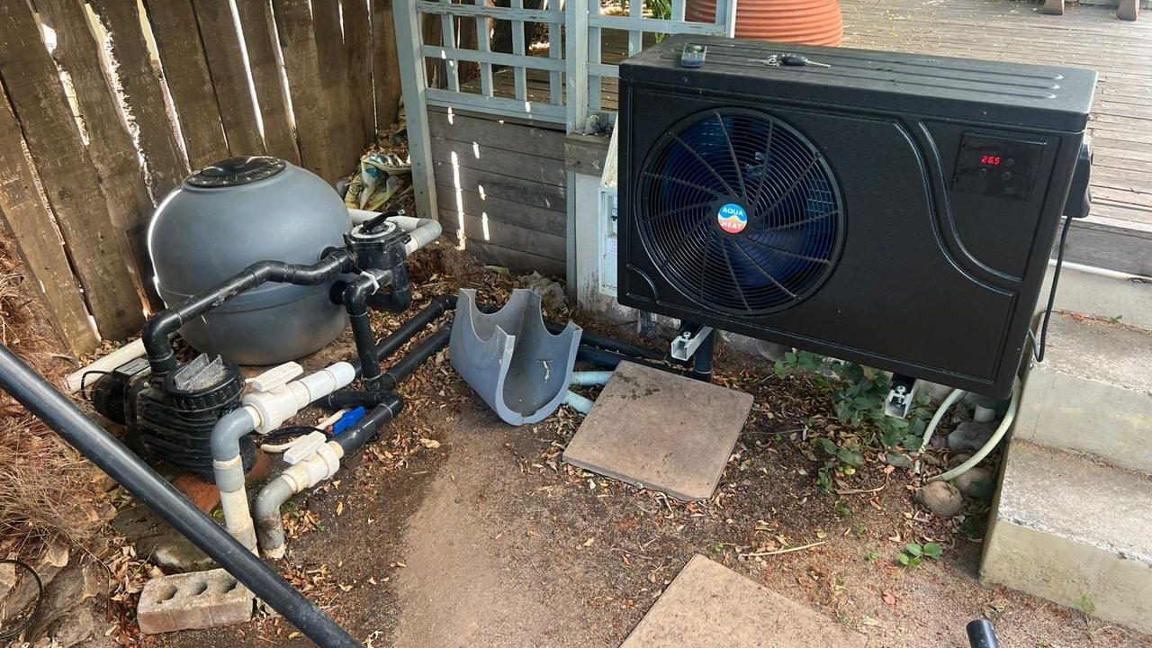Heat pump and solar panels connected to swimming pool