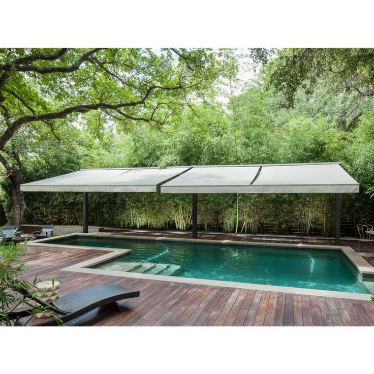 Stylish pool decking setup with shade and garden landscaping in South Africa.