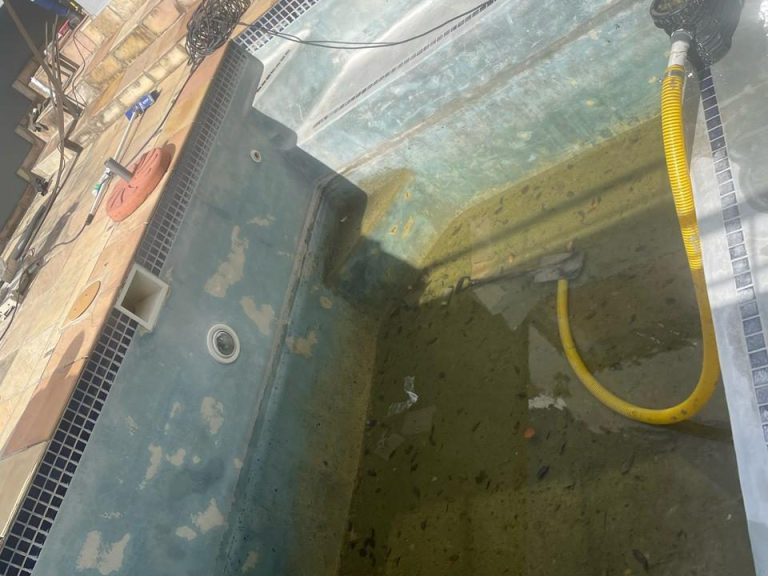 Drained fibreglass pool with a faded, worn gelcoat surface before restoration
