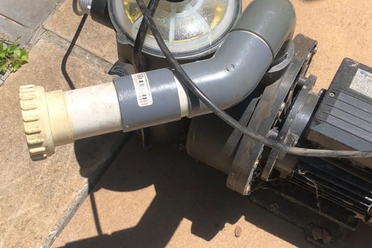 Technician performing professional pool pump replacement and installation service in Cape Town, South Africa.