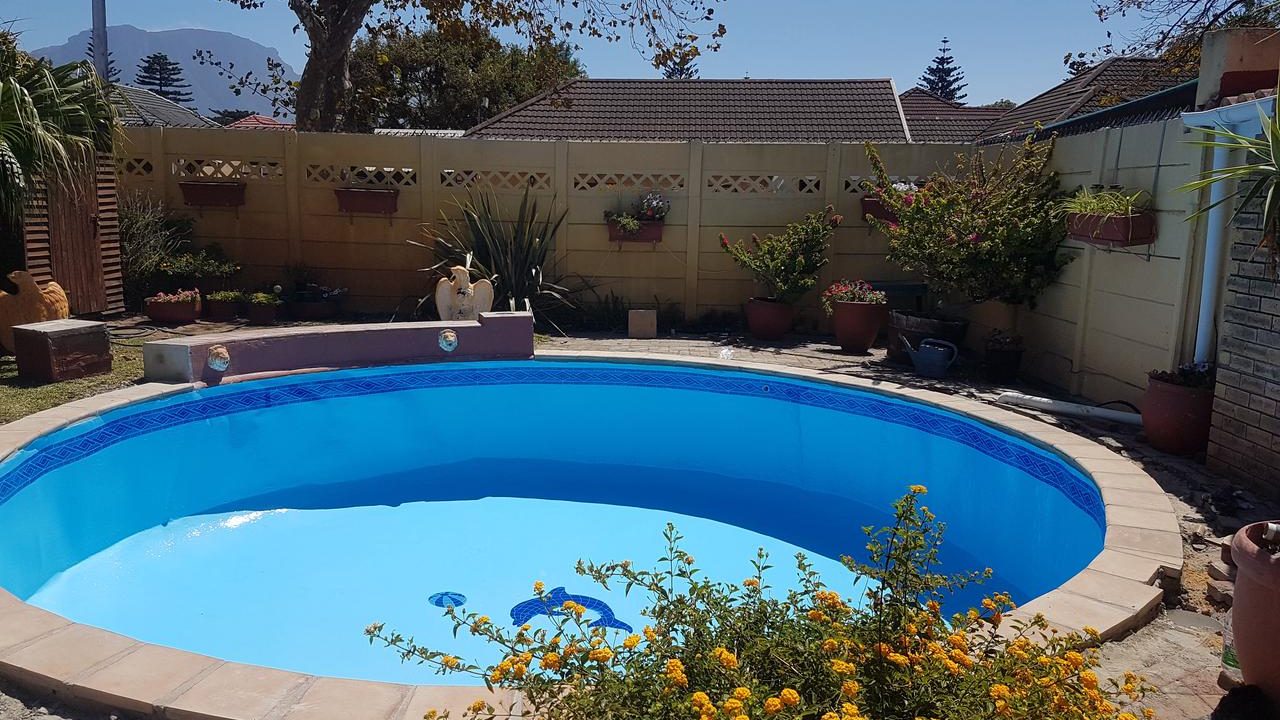 Freshly renovated swimming pool in Cape Town with fibreglass lining and upgraded paving