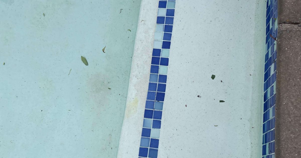 Gunite swimming pool steps with safety markings for non-slip entry and exit