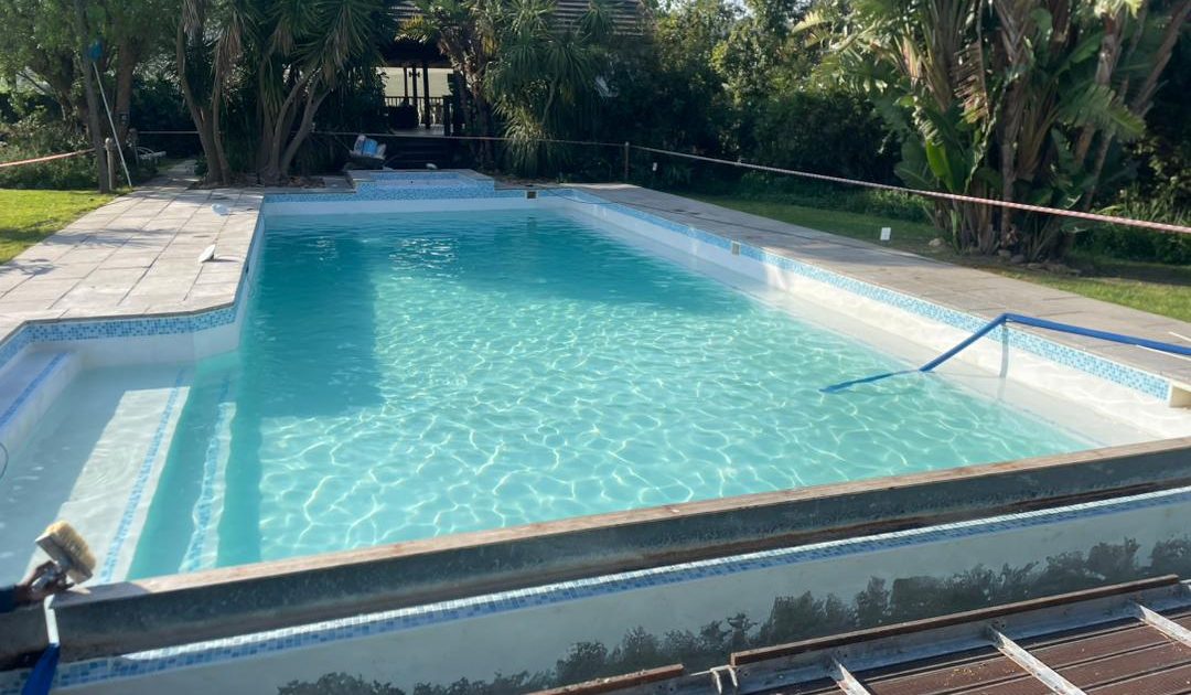Freshly finished swimming pool with a smooth marbelite lining, filled with crystal-clear water, showcasing durability and elegance in Cape Town.