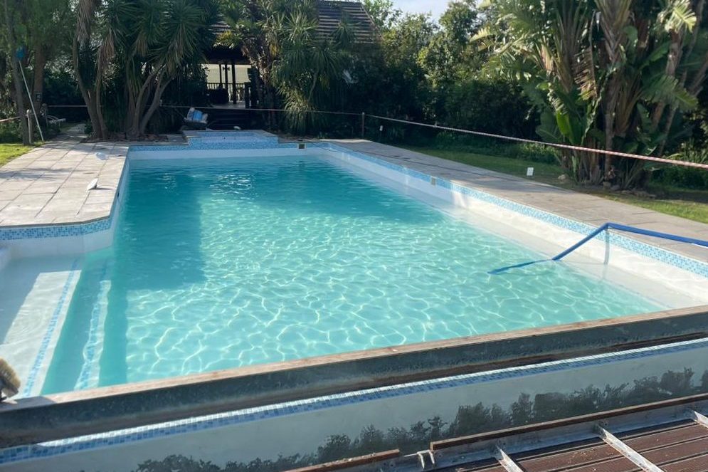 Freshly finished swimming pool with a smooth marbelite lining, filled with crystal-clear water, showcasing durability and elegance in Cape Town.