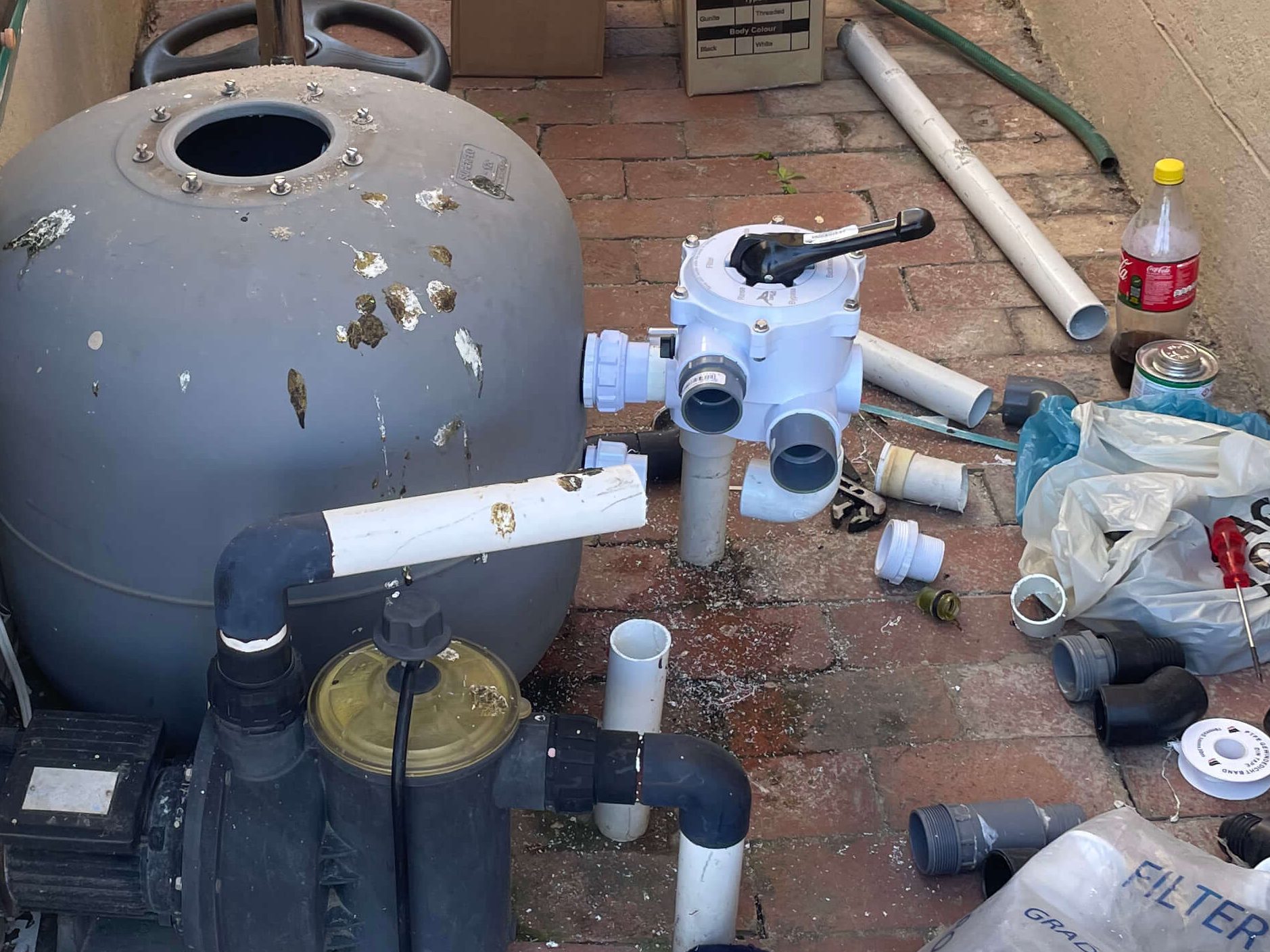 Technician replacing a damaged sand filter selector valve to restore proper pool filtration and water circulation in Cape Town