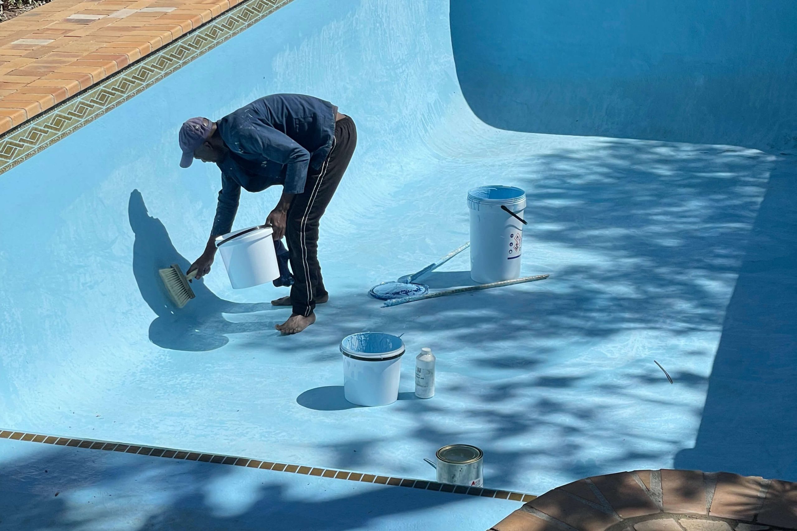 Technicians applying new fibreglass lining to repair bulging and cracked pool walls in Cape Town