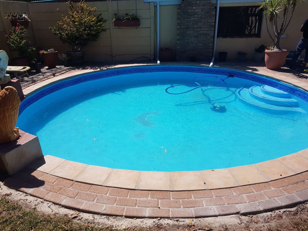 Side-by-side gallery showing a swimming pool before and after fibreglass relining and painting by Pools Reno in Cape Town, highlighting the dramatic transformation from old marbelite to a smooth, modern fibreglass finish.