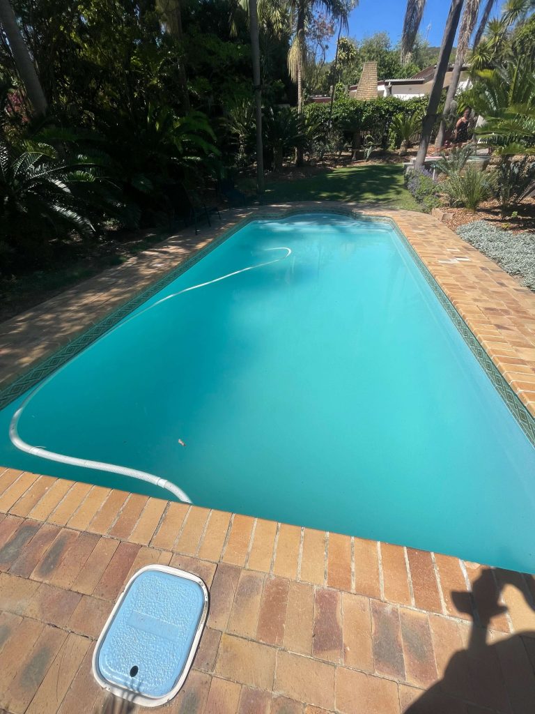 Completed fibreglass pool lining with a glossy blue finish after leak repairs
