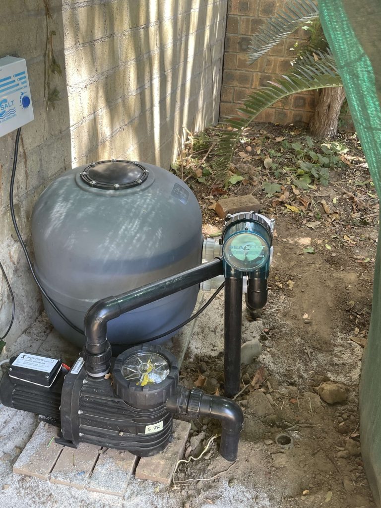 Professional pool technician installing a sand filter and pump system in Cape Town, ensuring efficient water circulation and crystal-clear pool water, completed by Pools Reno.