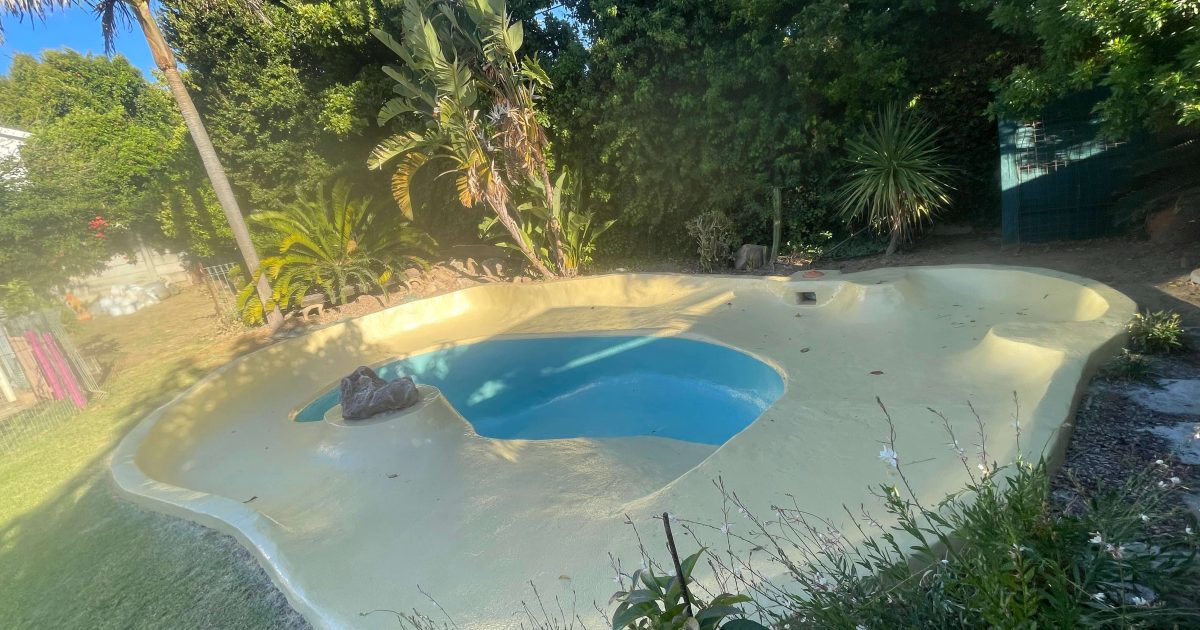 Newly fibreglass lined swimming pool painted with two colour gel coats in Atlantic Sea Board showing a smooth dual tone finish and durable modern pool renovation