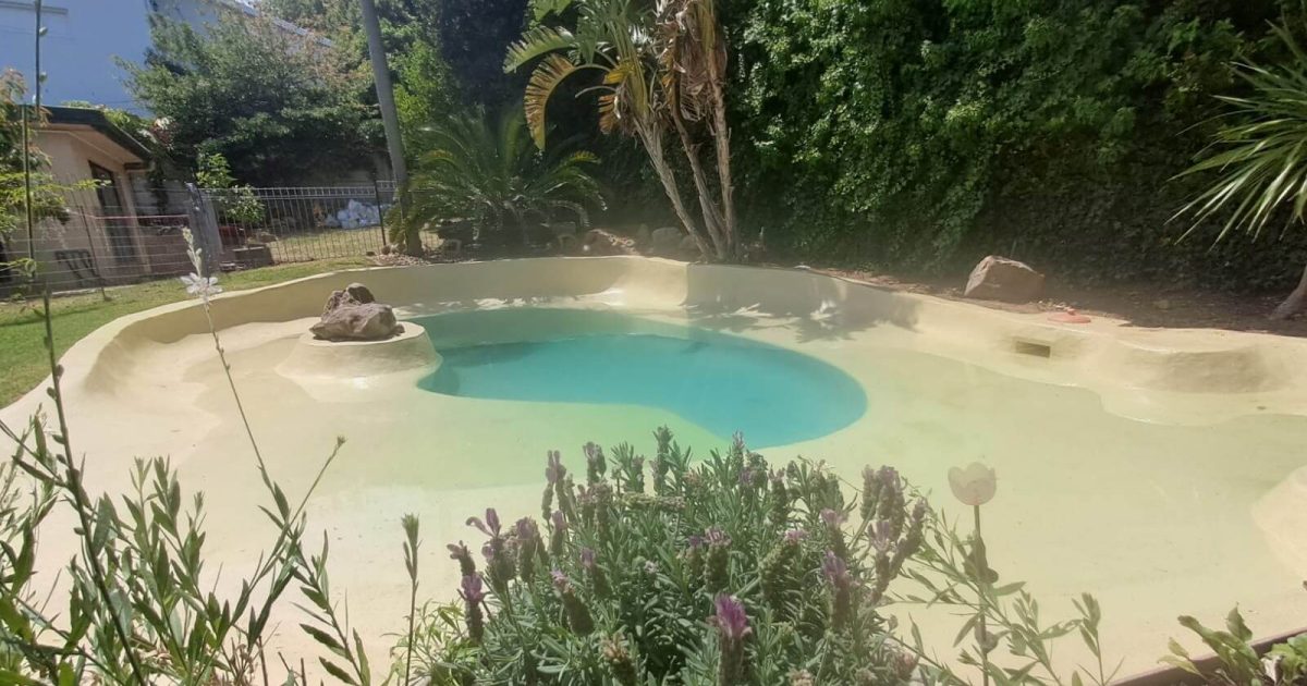 Newly fibrelined marbelite swimming pool in Cape Town, restored by Pools Reno with a smooth, watertight fibreglass finish and refreshed modern appearance.