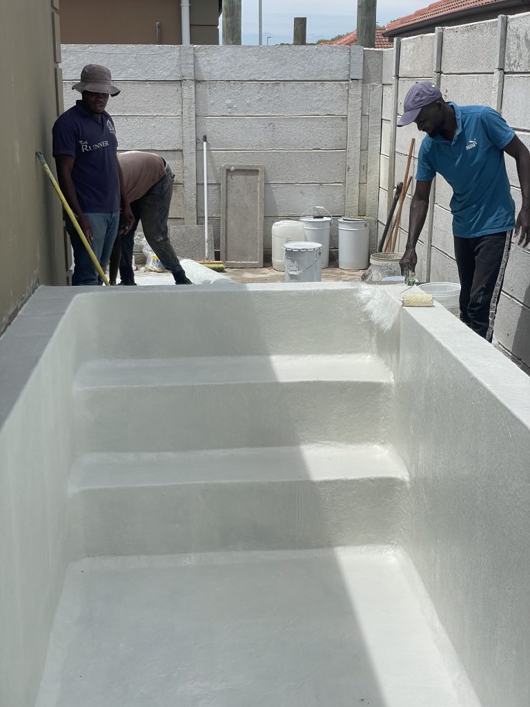 Fibreglass lining being professionally applied to a concrete swimming pool in Cape Town for a smooth, durable finish