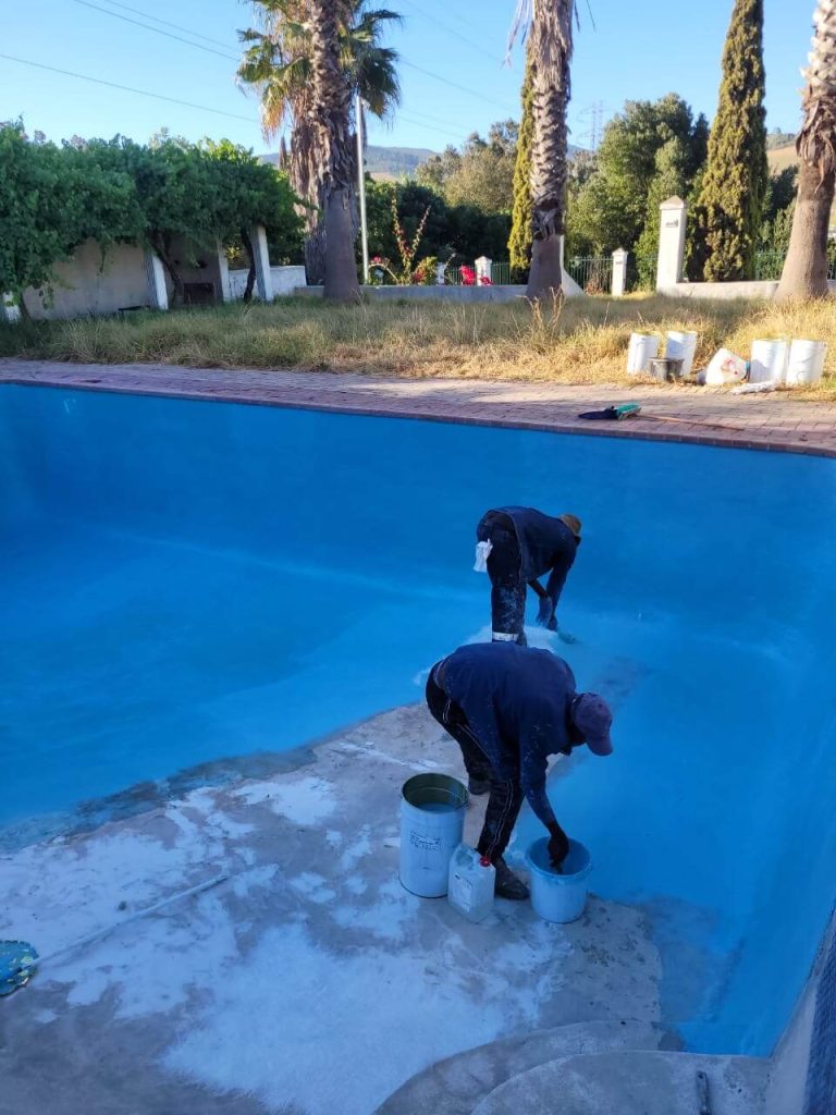 Fibreglass lining being applied to an old marbelite swimming pool in Cape Town to restore strength and durability