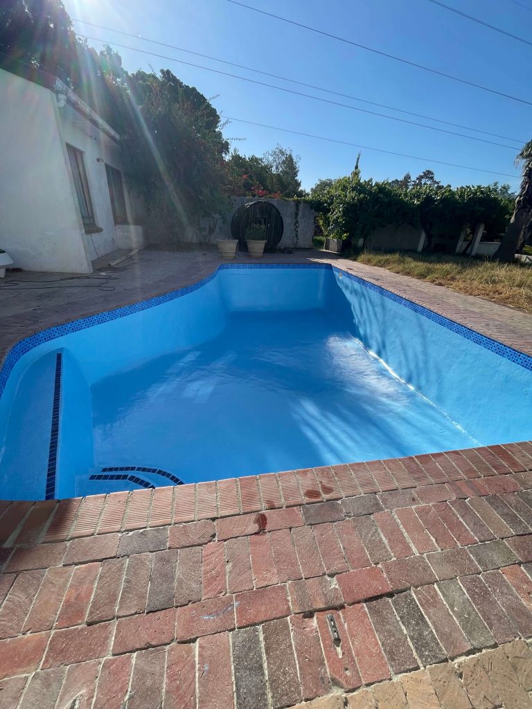 Fully renovated marbelite swimming pool in Cape Town after fibreglass resurfacing and painting, now clean, smooth, and like new