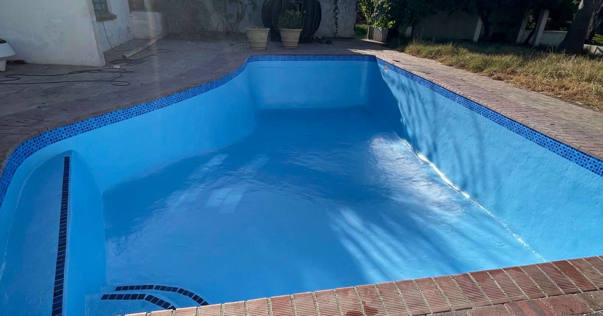 Old marbelite swimming pool newly renovated with fibreglass lining in Cape Town, creating a smooth and durable finish