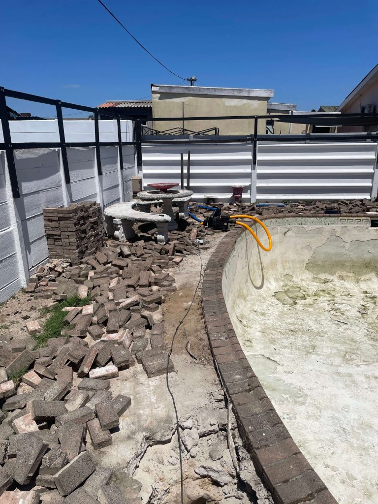 Swimming pool paving installation around a residential pool in Cape Town, featuring non-slip outdoor paving professionally laid by Pools Reno