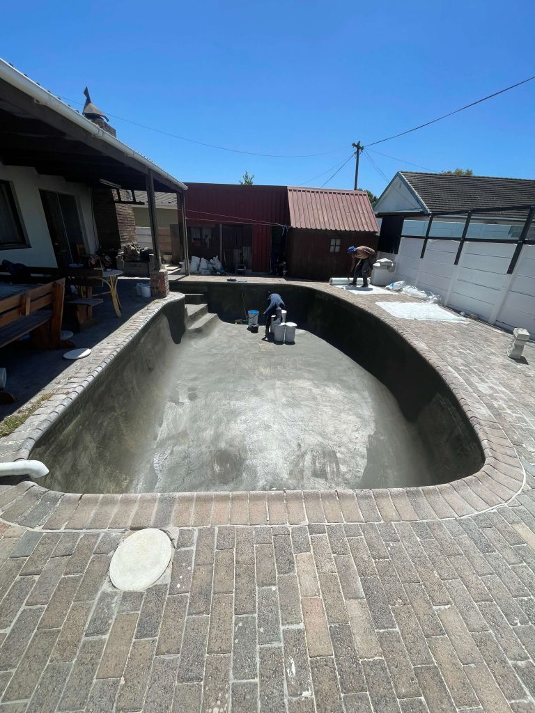 Damaged concrete swimming pool surface undergoing professional repairs before fibreglass lining in Cape Town by Pools Reno
