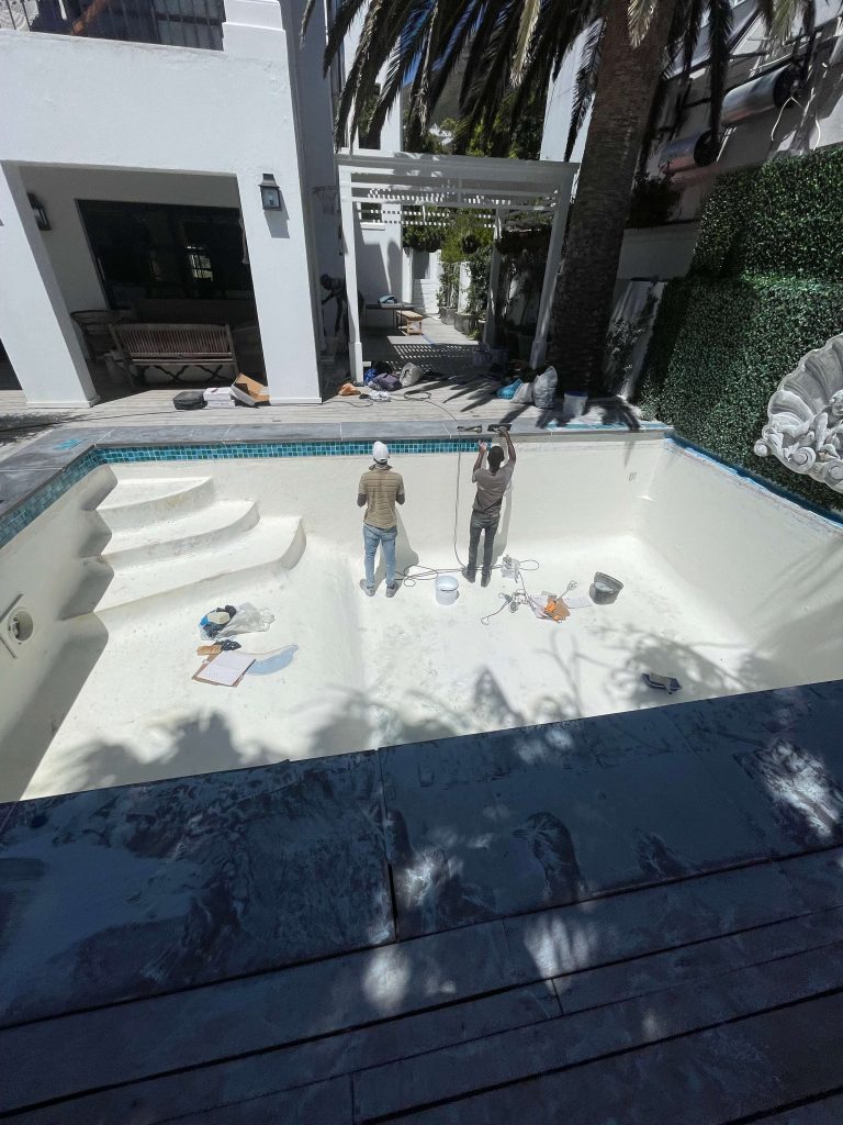 Installation of new ceramic mosaic tiles in a fibreglass lined concrete swimming pool by Pools Reno in Cape Town