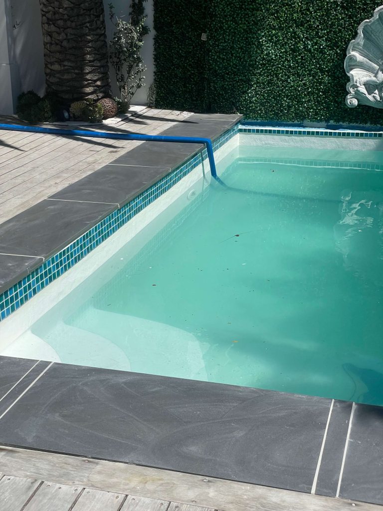 Newly installed ceramic pool mosaic tiles in a fibreglass lined concrete pool after professional renovation in Cape Town