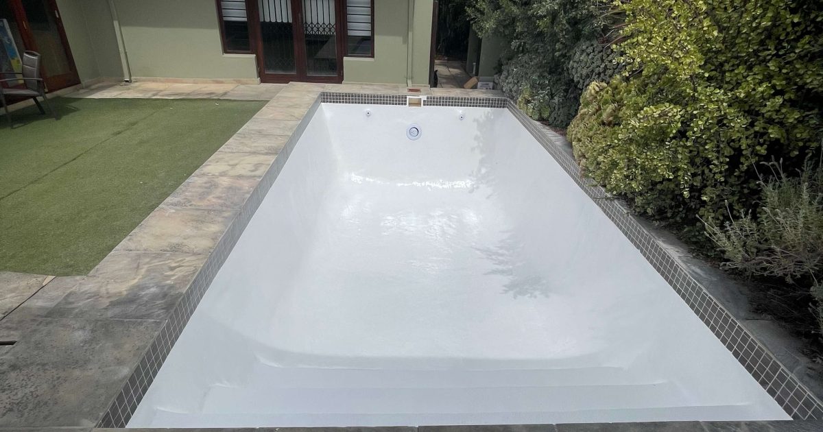 Newly renovated fibreglass swimming pool in Cape Town, completed by Pools Reno, featuring a smooth, durable finish and modern blue colour for long-lasting performance.