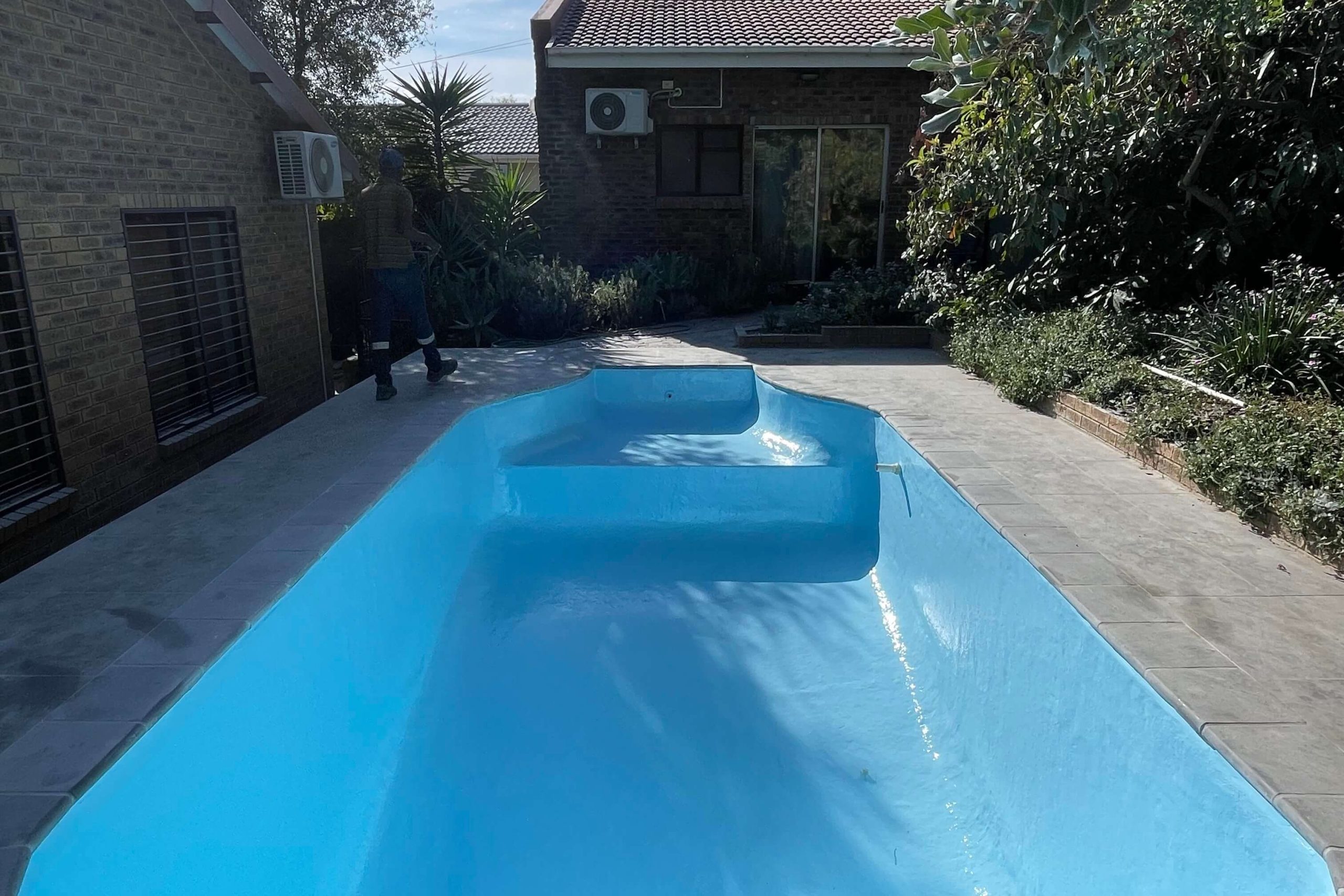 Fully renovated swimming pool in Wellington after fibreglass relining, fresh painting, plumbing upgrades, and deep cleaning to eliminate algae and fungal growth, completed by Pools Reno.
